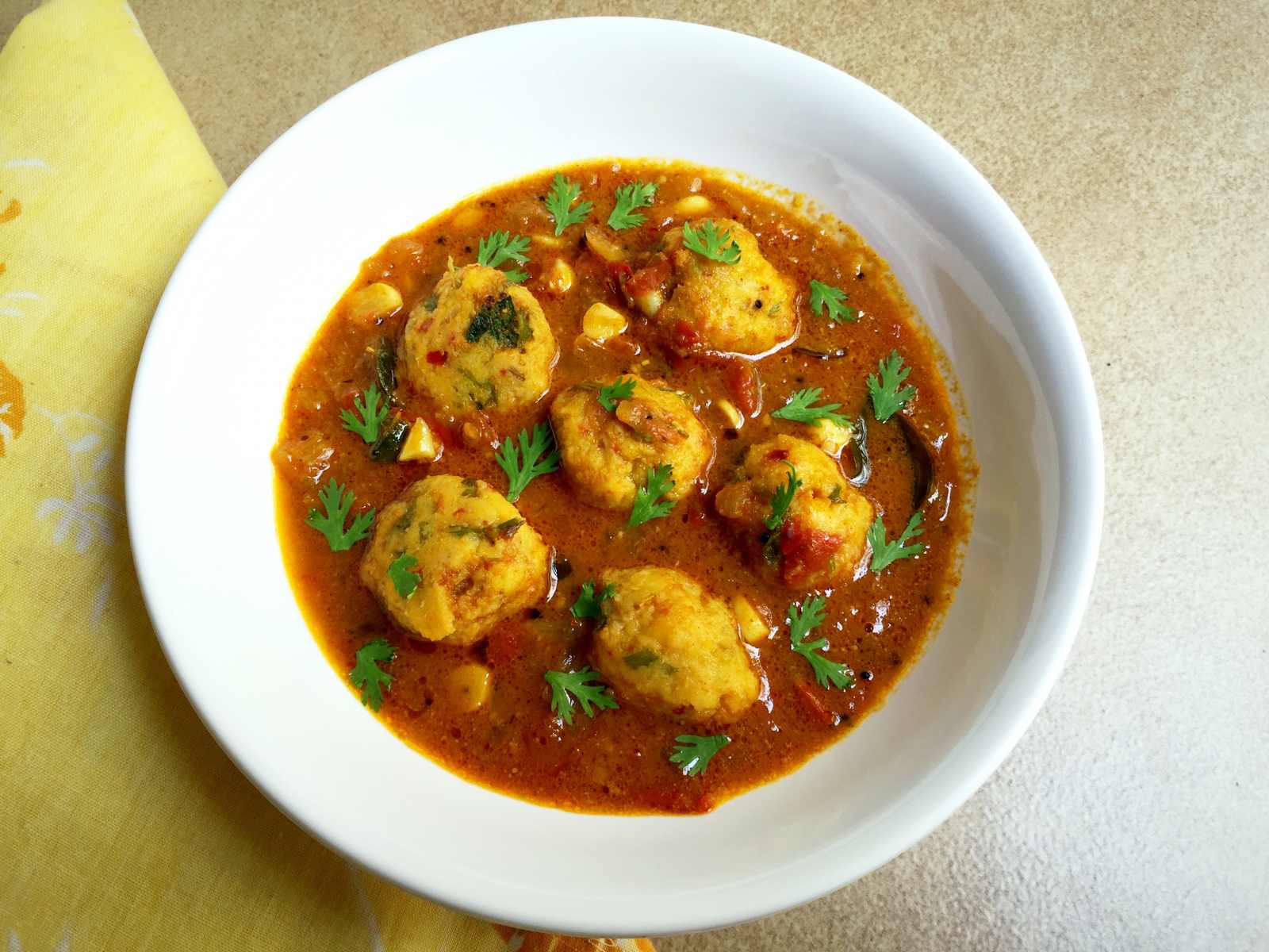 Chettinad Paruppu Urundai Kuzhambu (Steamed Lentil Balls Cooked in a Tangy Curry) Recipe
